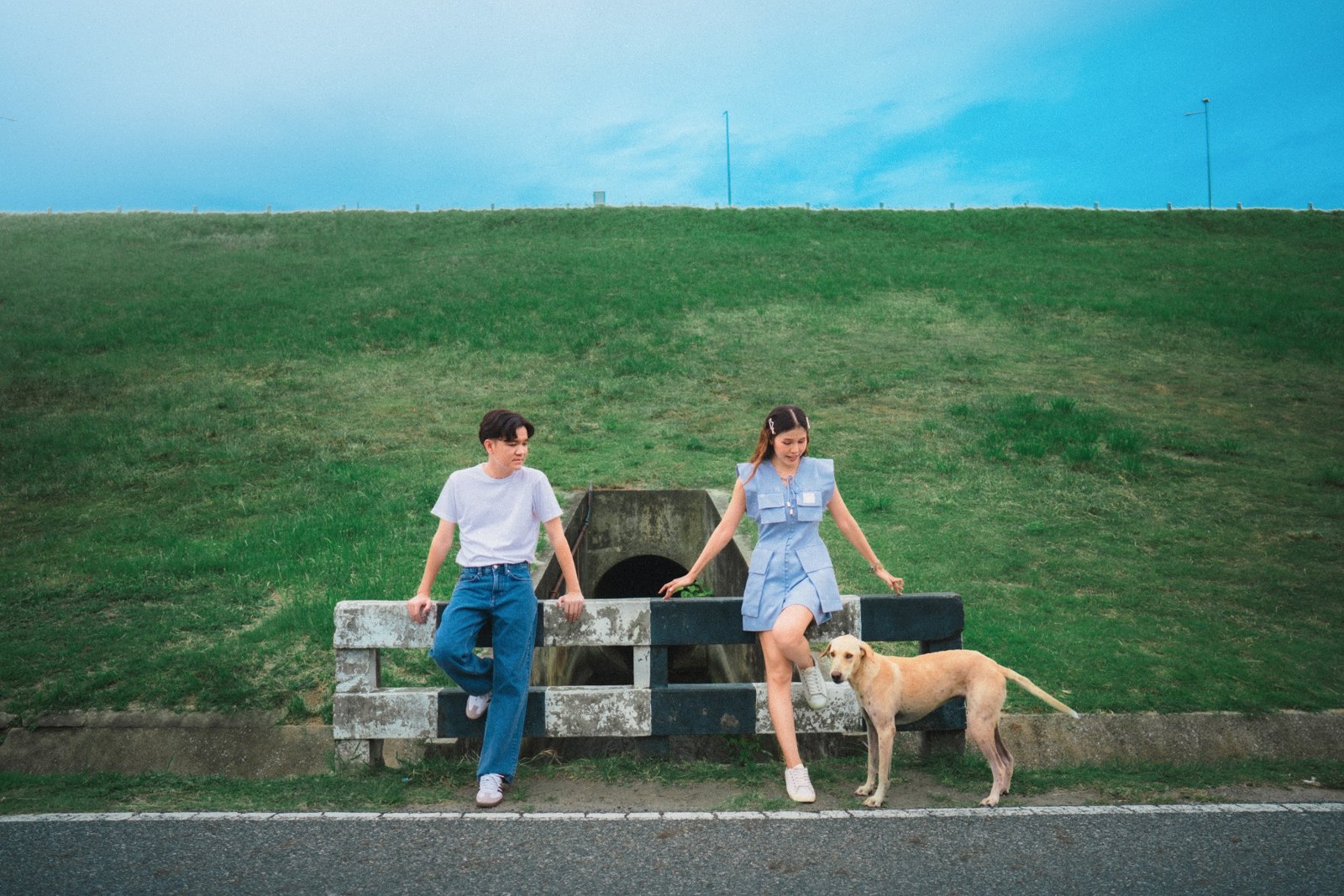 Amm and Hrung on a bench with a dog