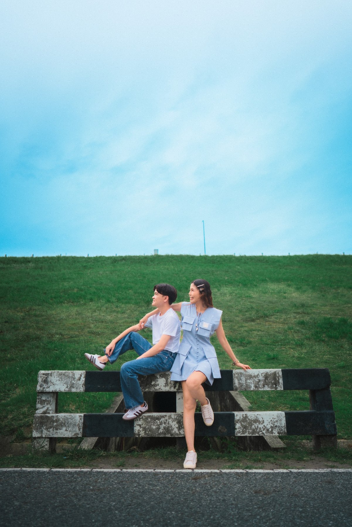 Amm and Hrung seated beneath a blue sky